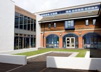 The quadrangle at the heart of the school is  made by adding a white-rendered extension to a red-brick nineties wing