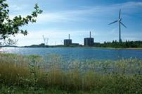 Olkiluoto 3 under construction. It will join two existing plants and a wind turbine. 