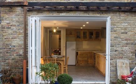 Extending the home has created a spacious kitchen/dining area and folding doors link the space to the garden